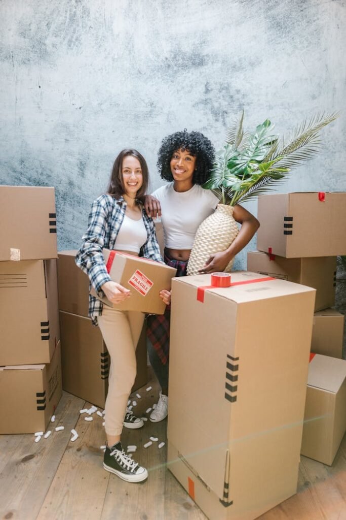 pexels-photo-7464478 A happy couple packing boxes inside their new home, surrounded by moving supplies.